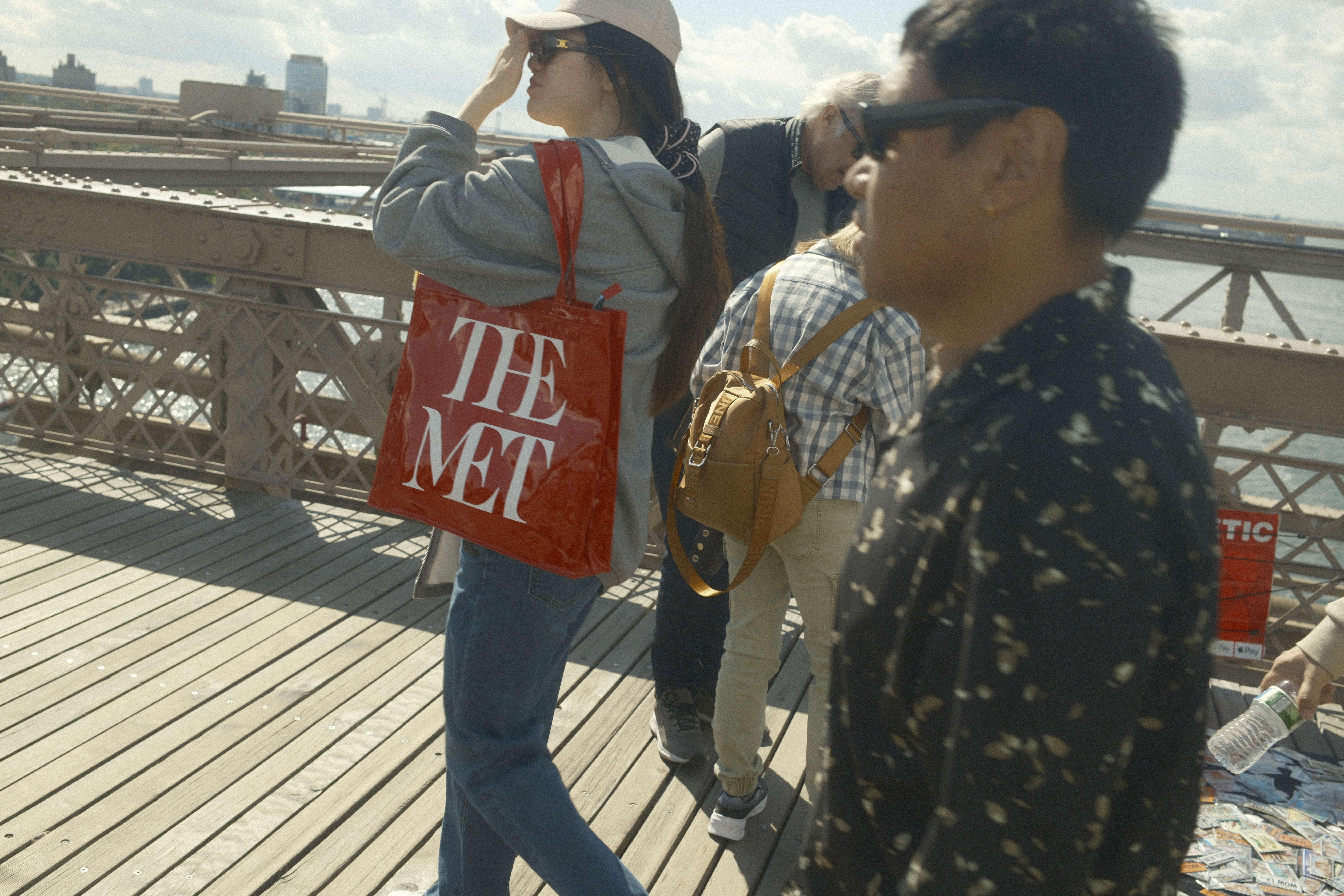 Women holding a bag that says The Met